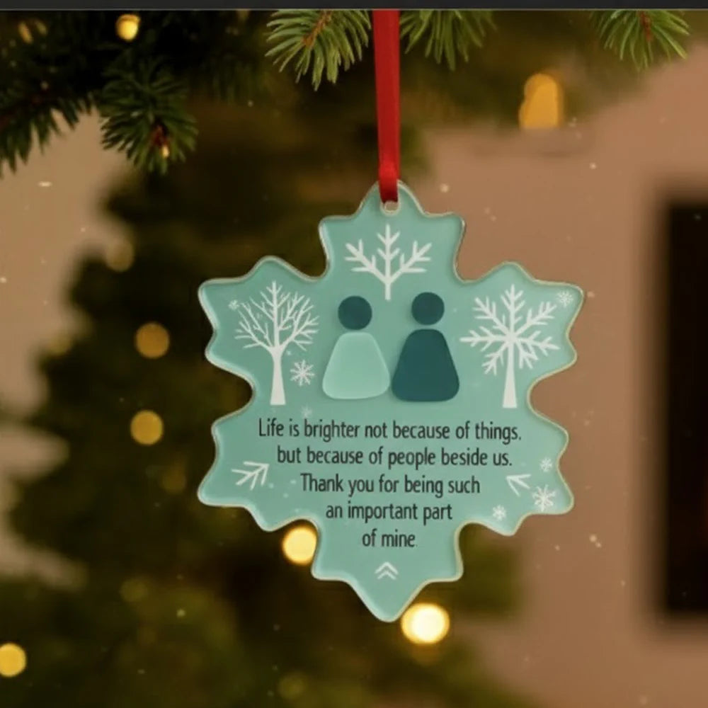 Decorative snowflake ornament with a message on a Christmas tree