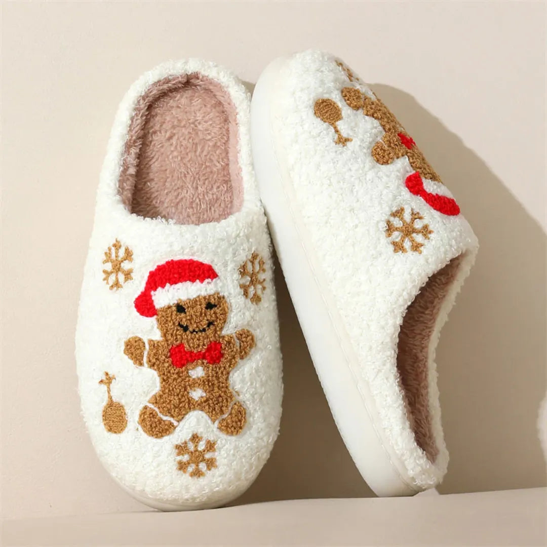 Pair of white slippers with gingerbread man design on a beige background