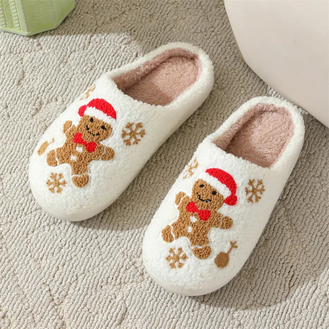 Pair of white slippers with gingerbread man design on a textured surface