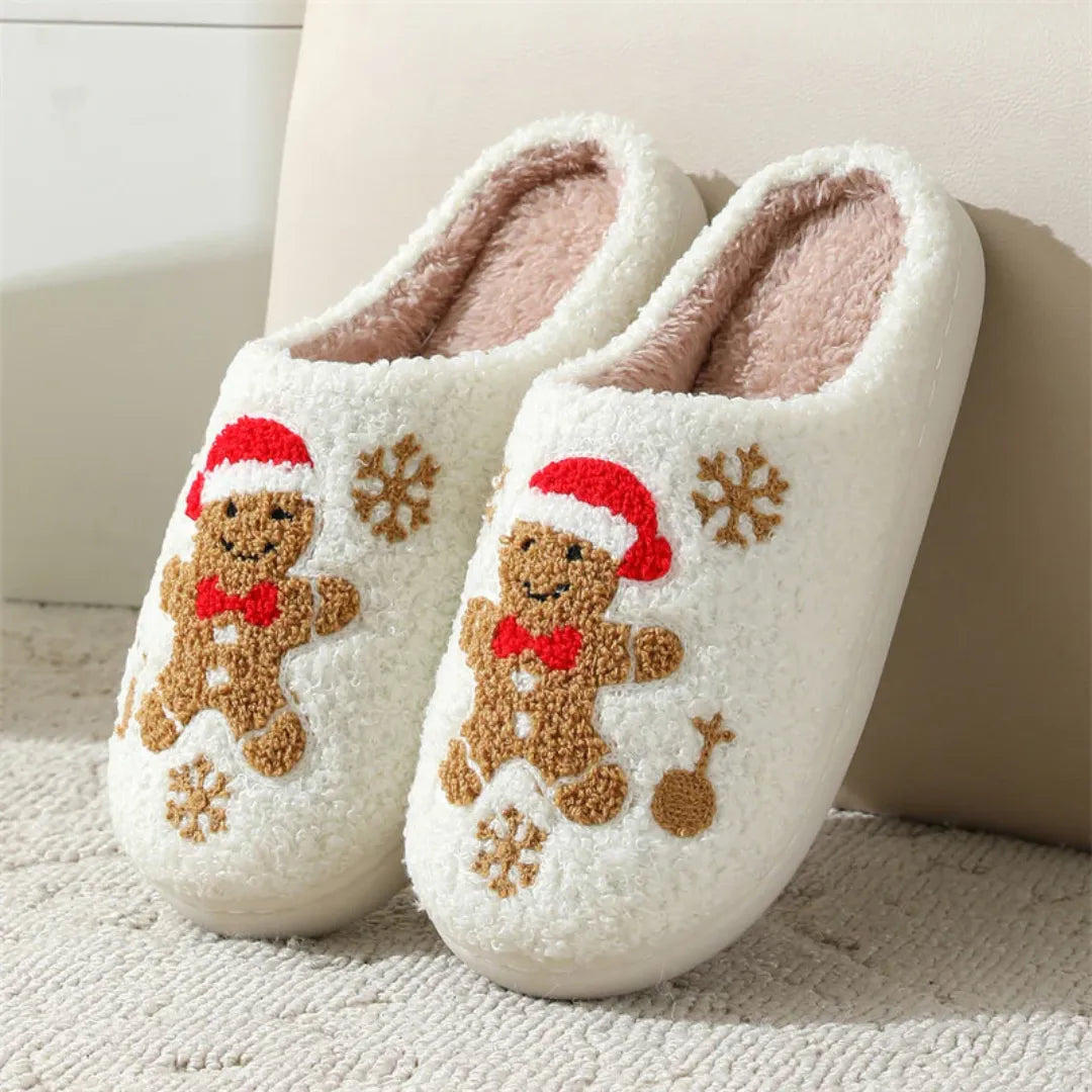 Pair of white slippers with gingerbread man design on a light background for family in christmas holiday
