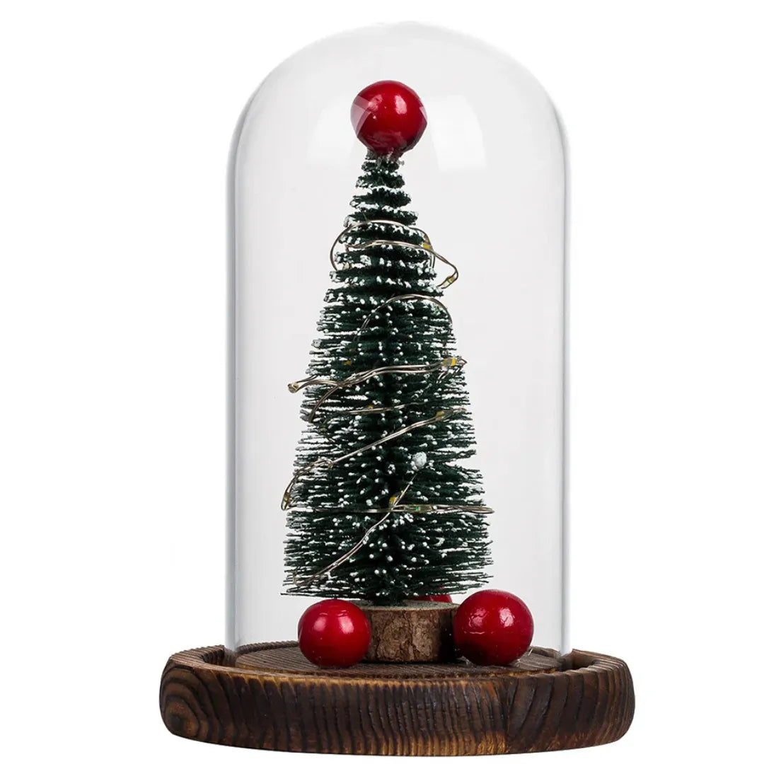 Decorative Christmas tree under a glass dome on a wooden base with red balls and led light.