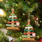 Two Christmas tree ornaments with custom name 'The Smith Family' on a decorated Christmas tree.