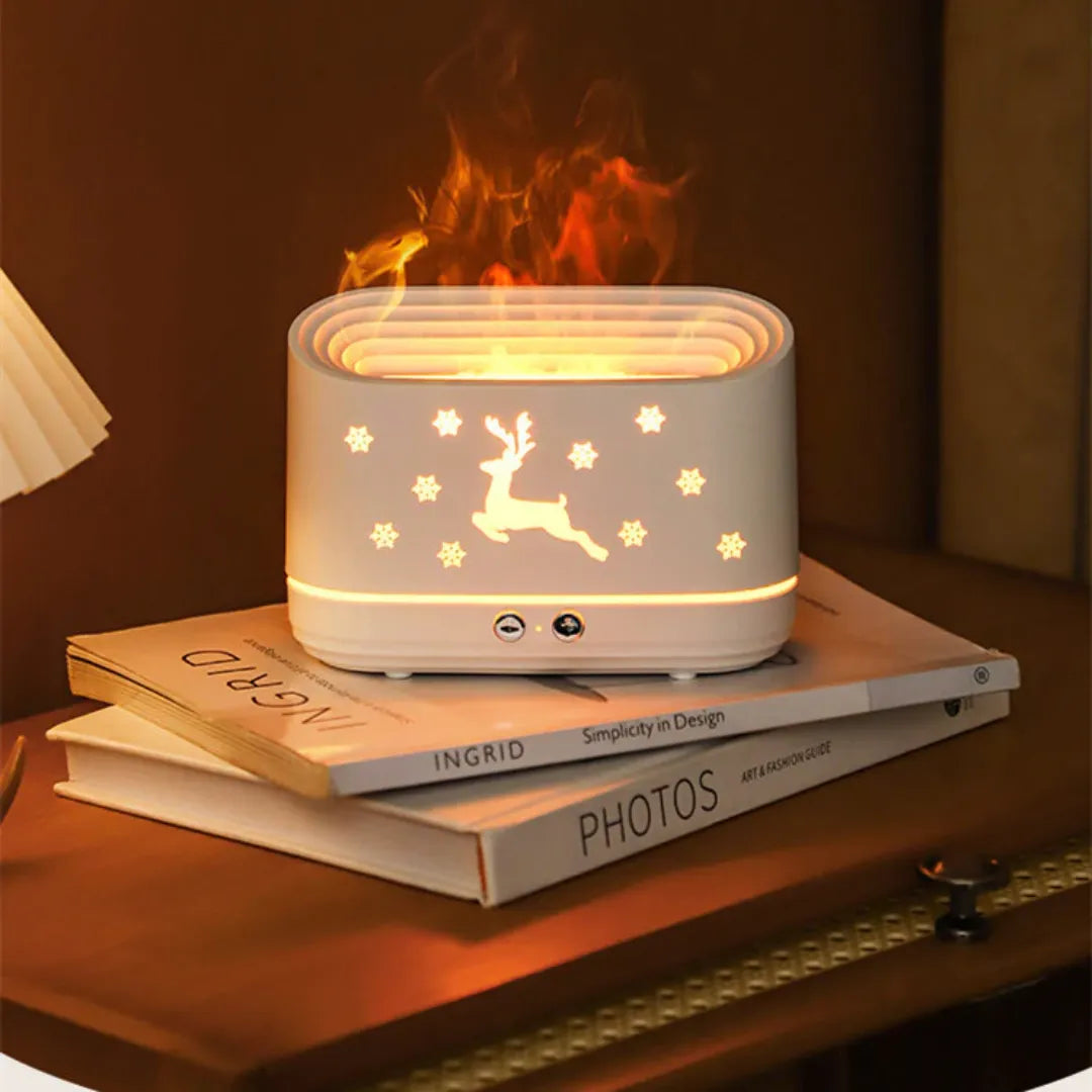 essential oil diffuser with flame effect on top of books