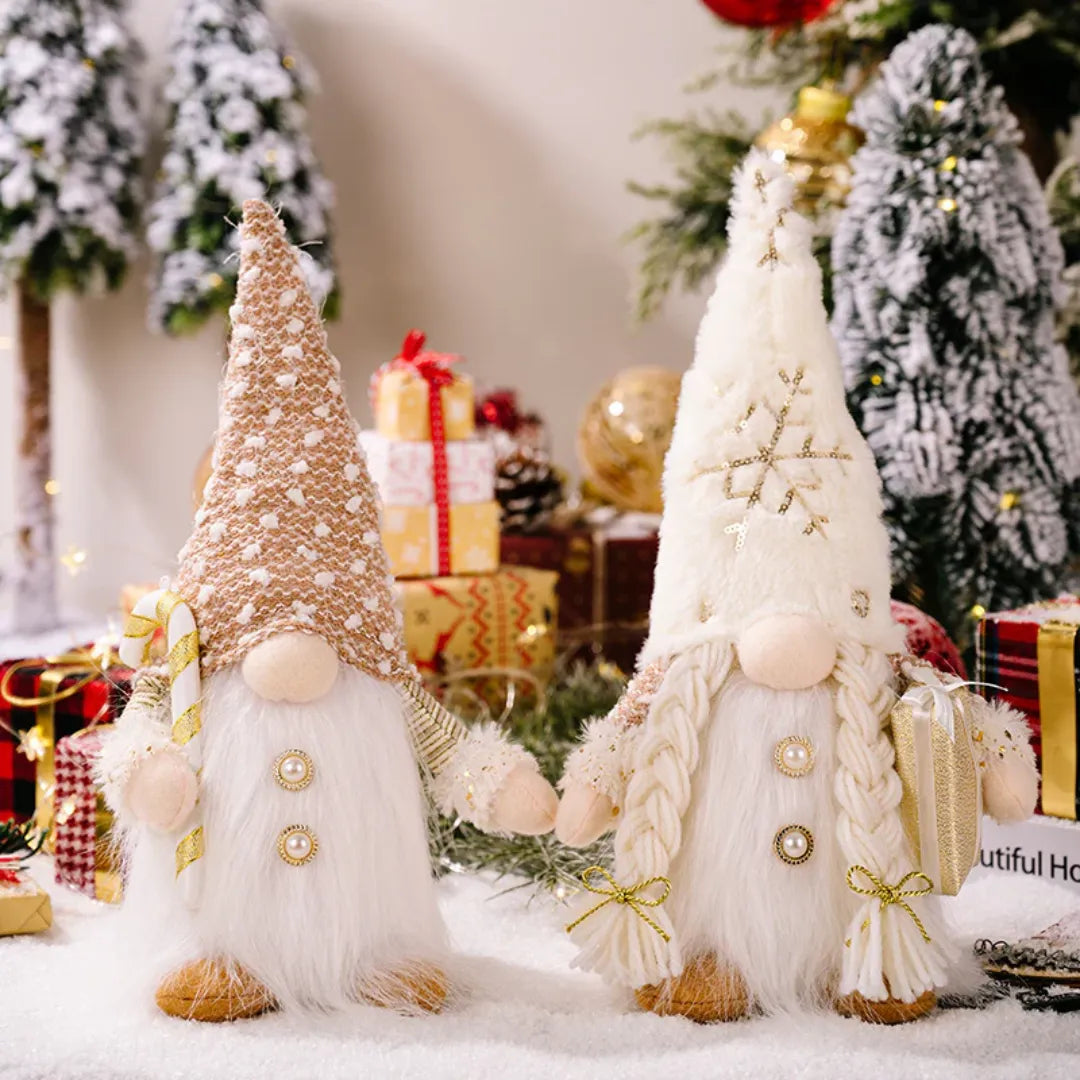 Two decorative Christmas gnomes in a festive setting with trees and presents.